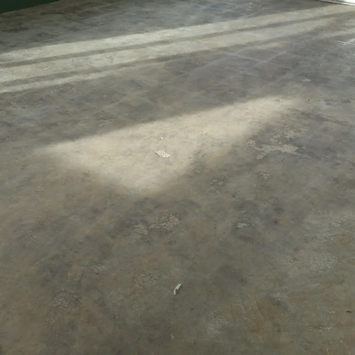 Retail entry before: raw stained concrete