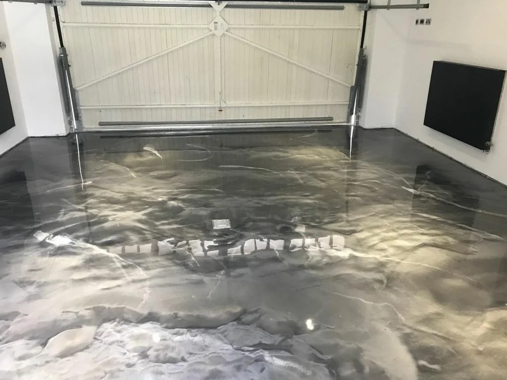Grey metallic epoxy garage floor with the door open