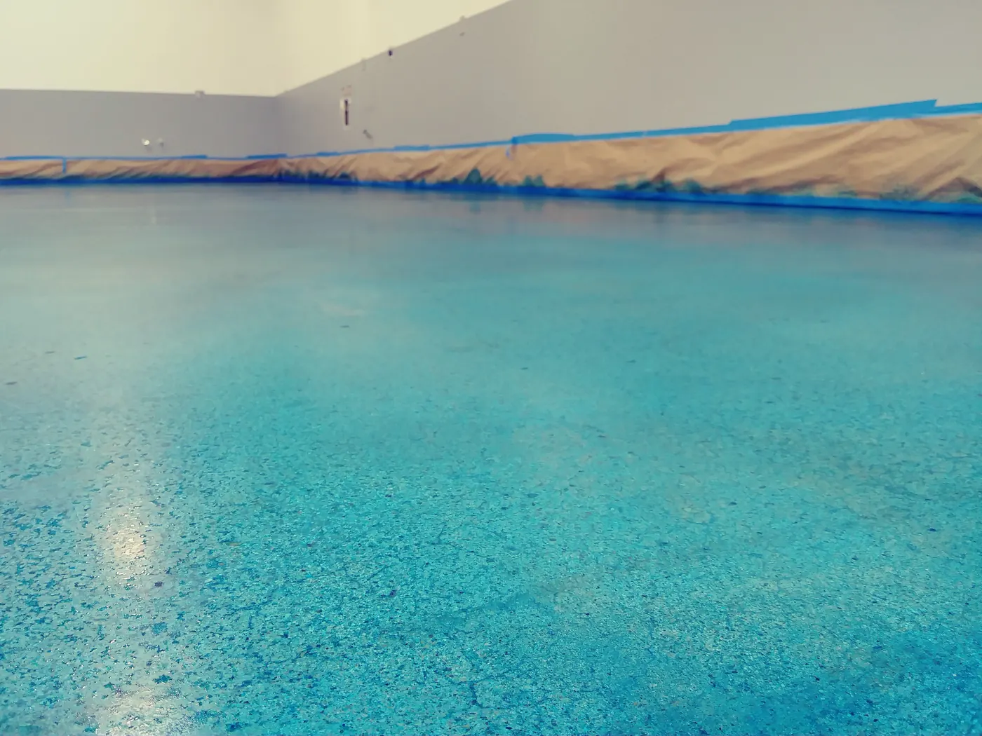 Teal metallic epoxy floor in a commercial space