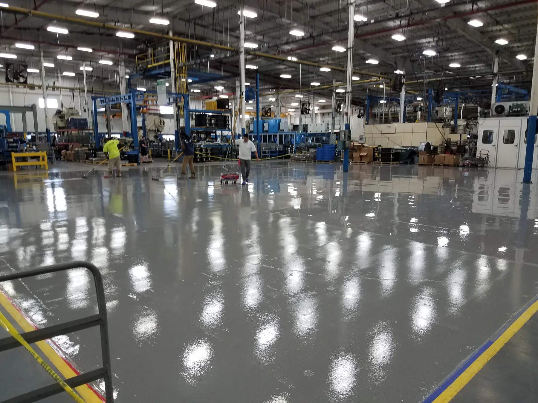 Manufacturing plant floor in grey epoxy with yellow safety striping